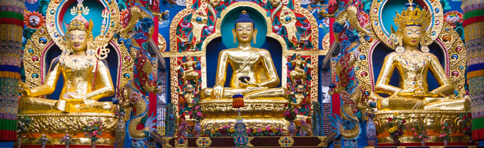 Monastery altar with the Buddhist deities Padmasambhava, Buddha and Maitreya.