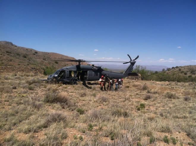 ParaRescuemen from a Tucson Air Force base escort a dazed McNally, along with Diamond Mountain searchers, to safety.